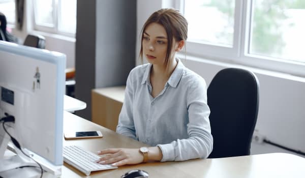 Administrative professional at desk in office